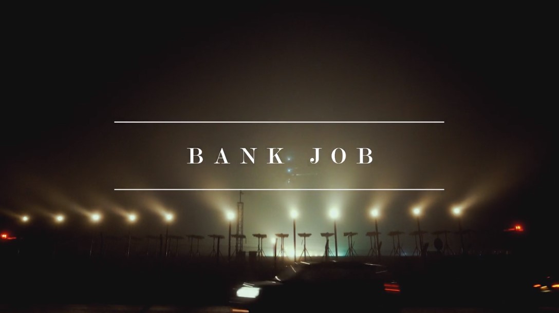 Plane landing at night with the title Bank Job